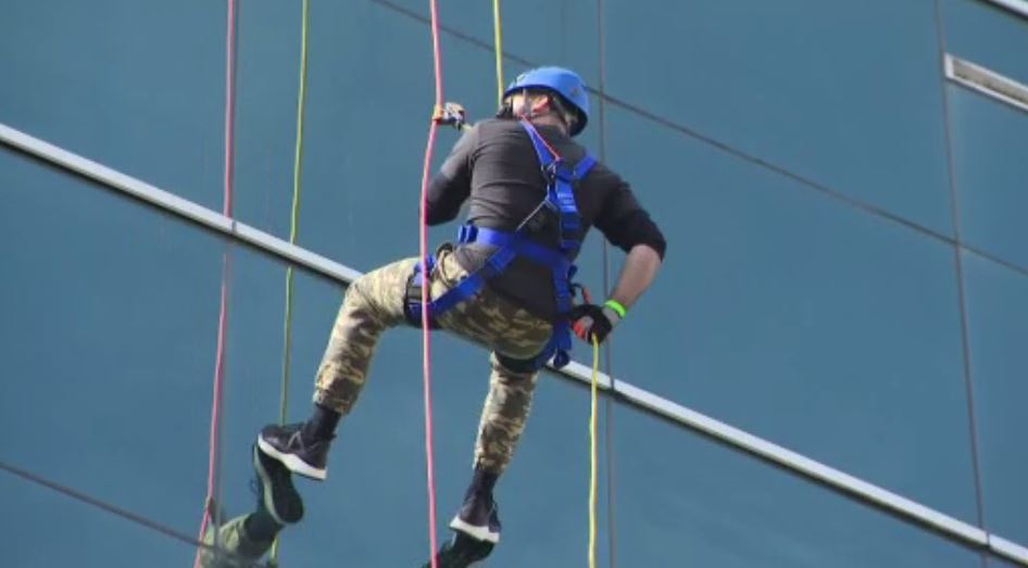 People rappel down Miami building to raise gun violence awareness