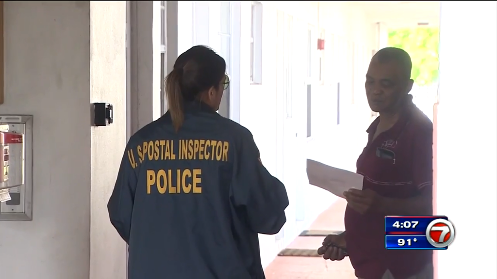 Postal inspectors pass out flyers to find crook who robbed mail carrier