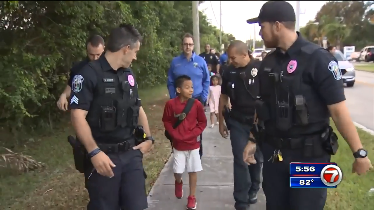 Hollywood Police officers walk with children, parents as part of