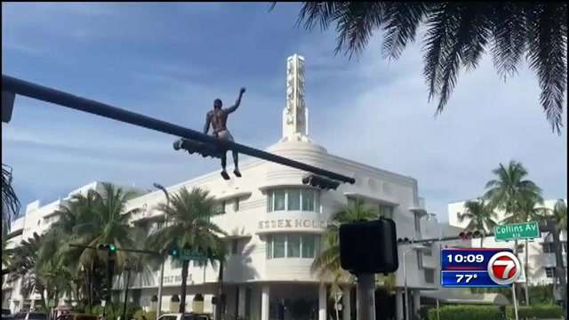 Man arrested after sitting atop South Beach traffic light, police foot ...