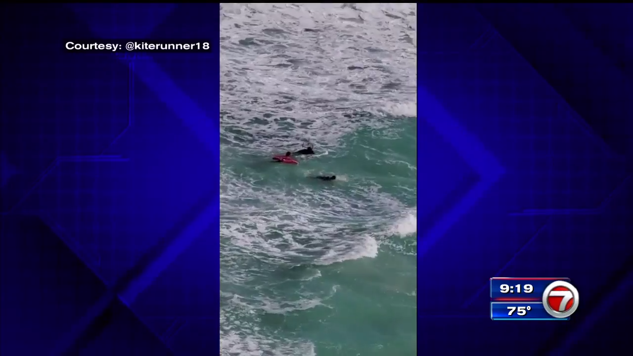 Kitesurfer swoops in to save struggling swimmer, lifeguards from rip
