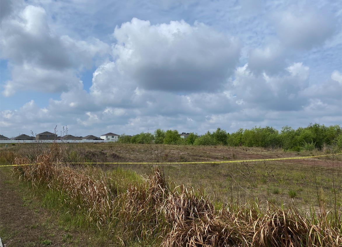 Dead body found burning in an open field, police investigating WSVN