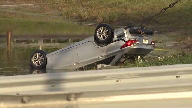 Man dead after car submerges into retention pond near Turnpike entrance ...