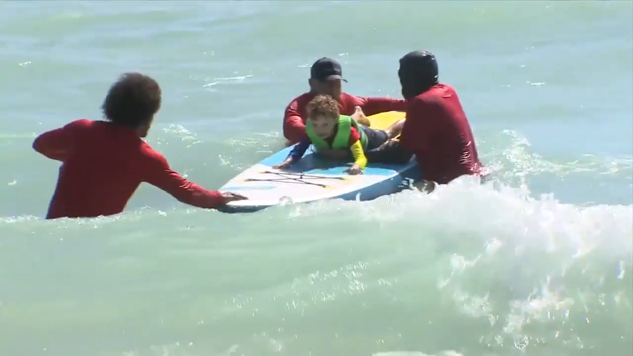 Children with autism sharpen swimming skills, surf during Spring Surf Camp