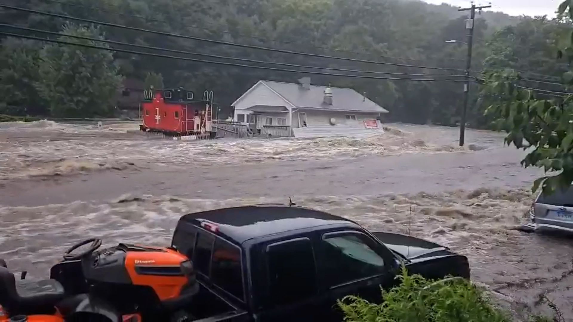 2 killed and about 100 evacuated by rescue crews as flash flooding hit
