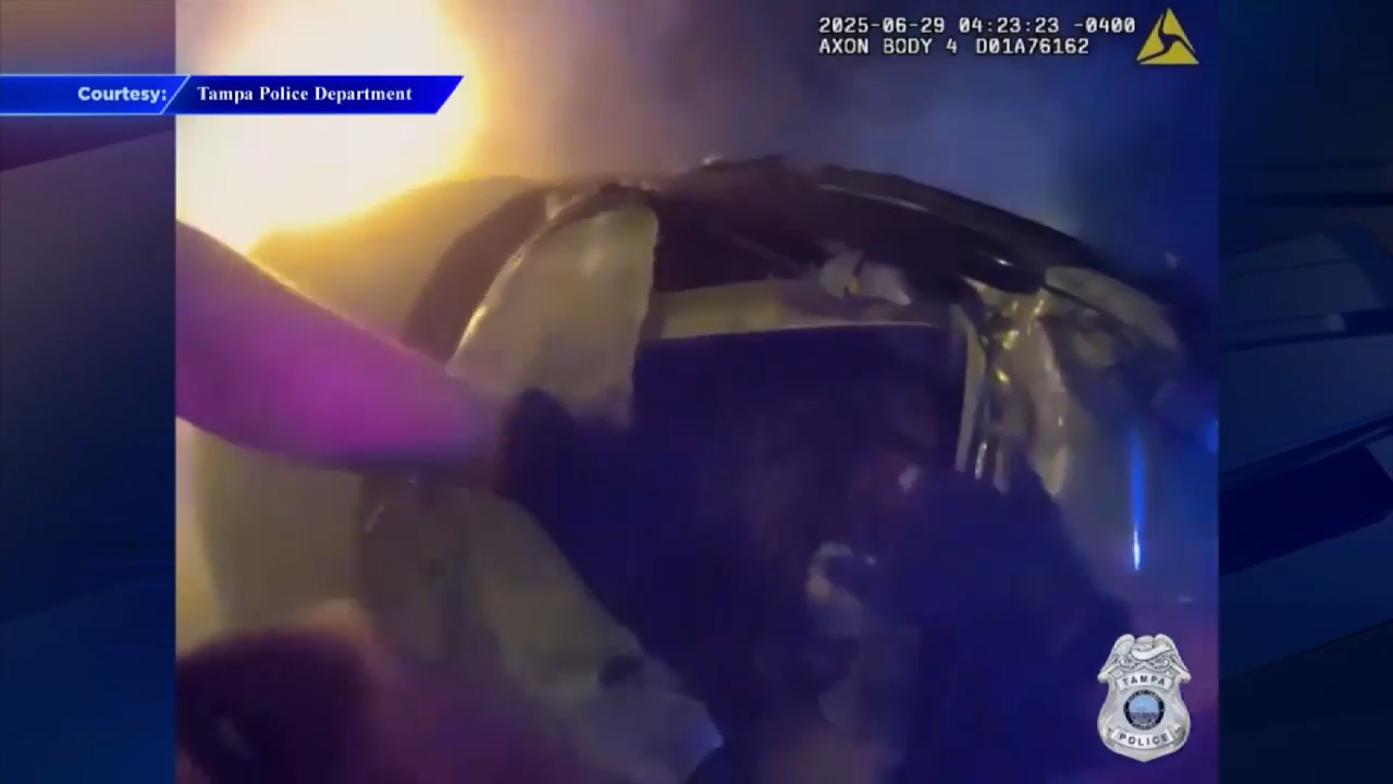 Woman rescued from burning car by police after rollover crash in Tampa ...