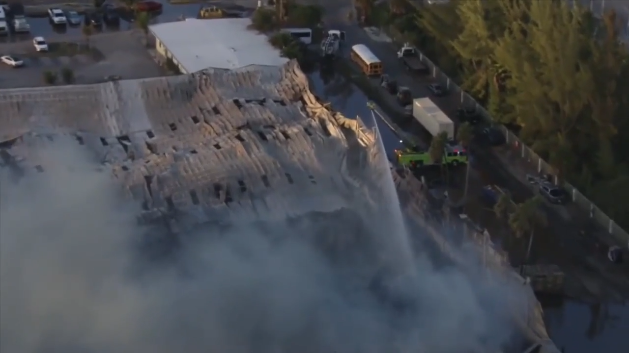 Crews clean up site for demolition as large warehouse fire slowly put under control near Turnpike in Northwest Miami-Dade
