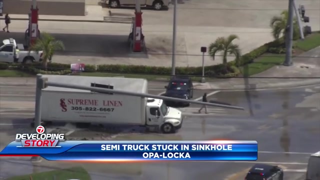 Crews remove semi-truck that became stuck in Opa-locka sinkhole caused by water main break; driver OK