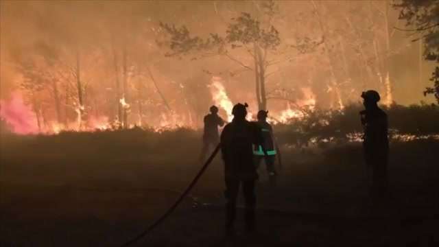 France says monster fire that forced 220,000 people to flee has stopped growing