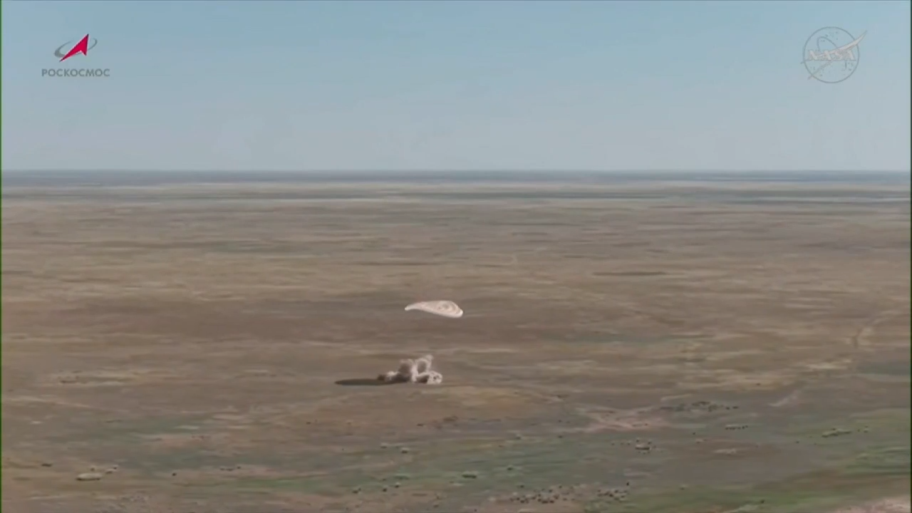 A US-Russian space crew lands safely in Kazakhstan after an 8-month stint on the ISS