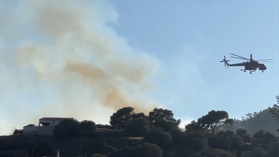 Firefighters battle massive wildfires in Belgium and Greece as 2 die on an island near Athens