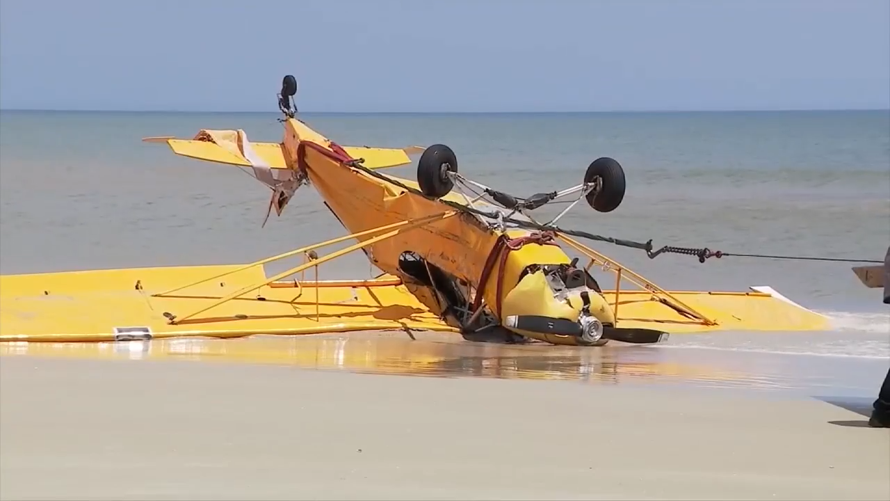 Witnesses share accounts of banner plane crash off New Smyrna Beach; pilot OK