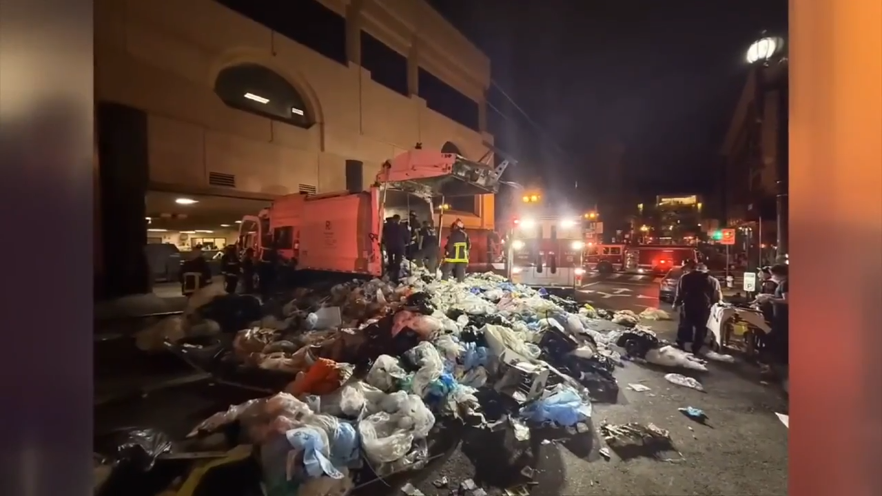 San Francisco firefighters rescue person trapped inside garbage truck