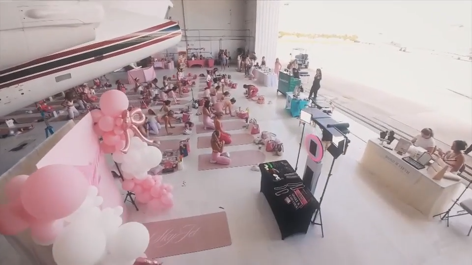 Buckle up and reach for the skies for a pink Pilates class next to private jets