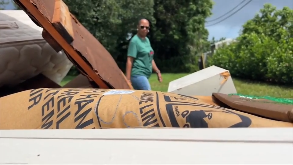 Someone dumped trash in her yard, who cleans it up?